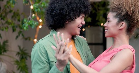 Joyful couple embracing during a special moment on outdoor terrace