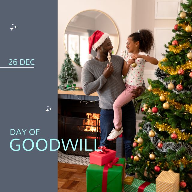 Composition of day of goodwill text over african american father with daughter at christmas. Day of goodwill, goodness and christmas concept.