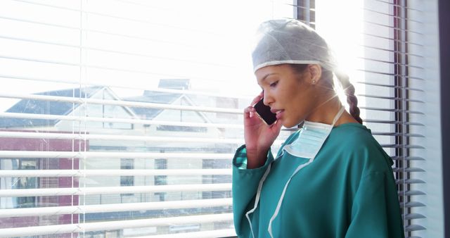 Nurse talking on mobile phone in hospital