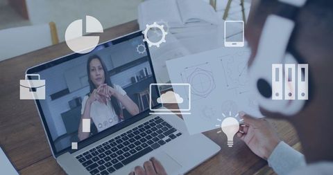 Man analyzing blueprint during video call home office setup