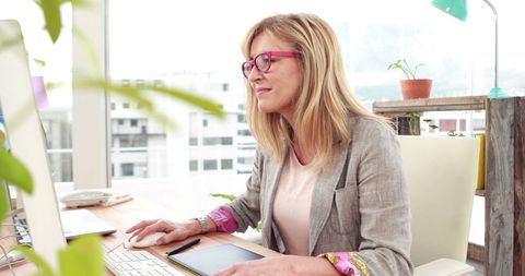Focused Caucasian Businesswoman Working at Bright Office Desk - Download Free Stock Images Pikwizard.com
