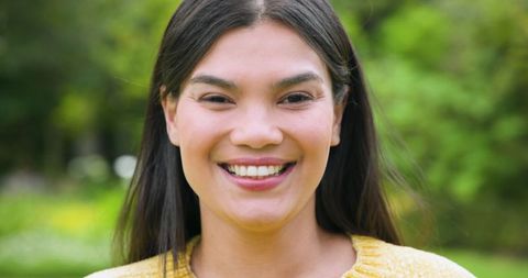 Smiling Mid Adult Woman in Yellow Sweater at Park