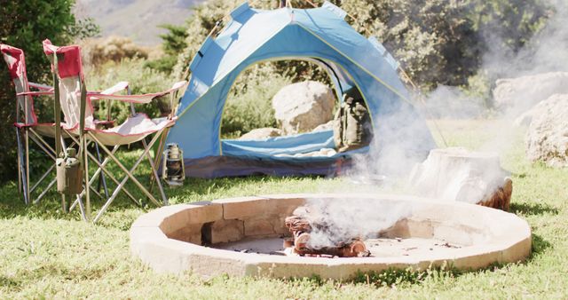 Blue Tent and Campfire at Serene Mountain Campsite - Download Free Stock Images Pikwizard.com