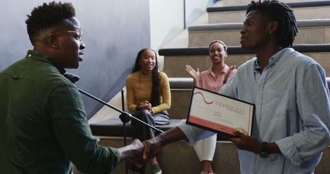 African american colleagues celebrating award recognition together