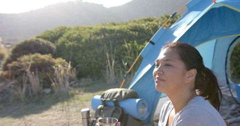 Woman Camping in Mountains Enjoying Outdoor Adventure