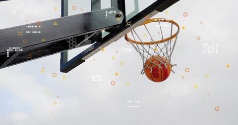 Orange basketball descending through hoop with futuristic hud overlay and backboard