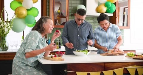 Happy seniors preparing dinner party at home