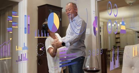 Mature couple dancing at home with augmented reality graphs, cozy wine-filled evening