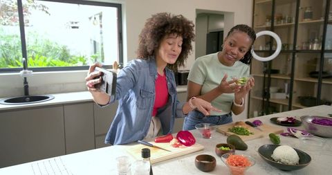 Diverse Friends Filming and Preparing Colorful Meal at Kitchen Island for Social Media