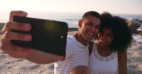 Young Couple Smiling while Taking Selfie on Beach - Download Free Stock Images Pikwizard.com