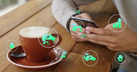 Man tapping smartphone at cafe with green eco notifications over latte, app analytics