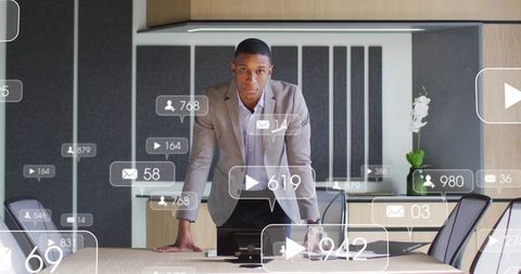 Executive leaning on boardroom table presenting social media engagement stats and analytics