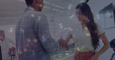 Diverse Businesspeople Shaking Hands Amidst Technology and Finance Graphics