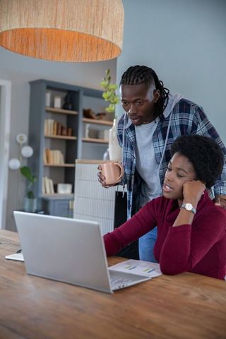 African American Couple Collaborating at Home Office