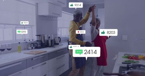 Joyful Senior Couple Dancing While Cooking in Modern Kitchen