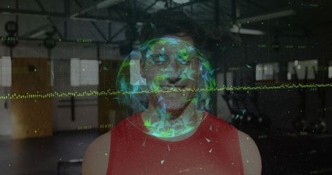 Athlete wearing red tank top training at industrial gym with holographic data globe