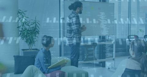 Startup team presenting data-driven strategy on whiteboard while colleagues collaborating