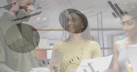 Team Analyzing Data with Financial Charts in Modern Office