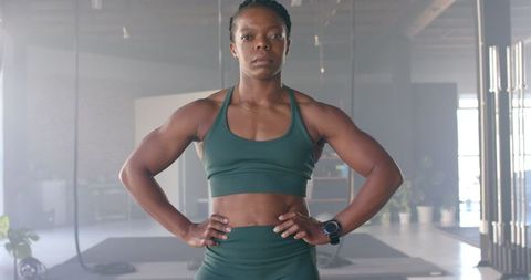 Confident Athletic Woman Posing in Modern Gym Setting