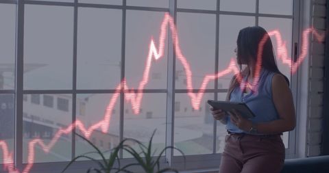 Businesswoman Analyzing Financial Data in Office with Graph Overlay