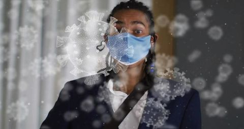 Man wearing surgical mask in modern office with digital coronavirus particle overlays