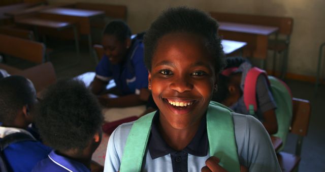 Smiling African American Boy with Backpack in School Classroom - Download Free Stock Images Pikwizard.com