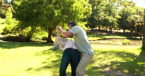 Father and Daughter Playing in Sunny Park