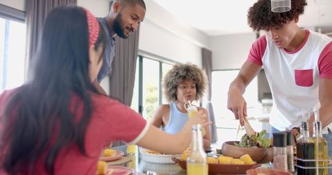 Diverse Group of Friends Sharing Meal at Home