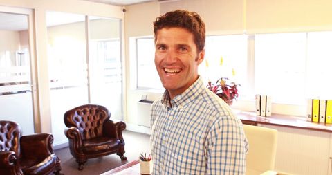 Confident business executive smiling in modern office interior