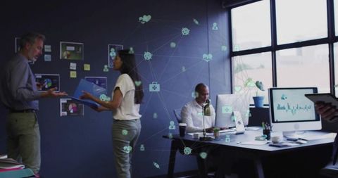 Office team collaborating with digital network icons