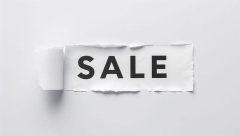 Minimal torn paper revealing bold SALE typography on white background