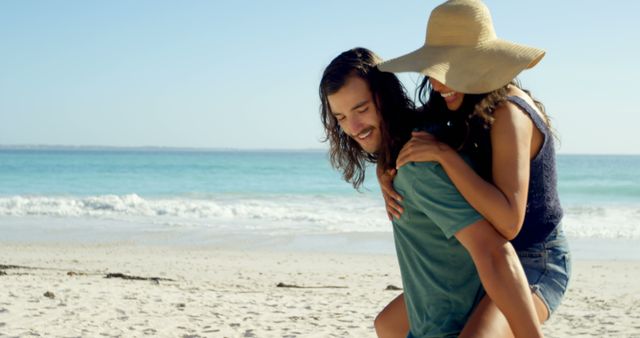 Happy Couple Enjoying Piggyback Ride on Sandy Beach - Download Free Stock Images Pikwizard.com