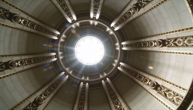 Radiant neoclassical dome with oculus casting radial daylight over gilded medallions
