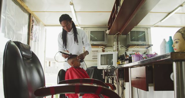 African American Barber Giving Haircut to Young Boy in Barber Shop - Download Free Stock Images Pikwizard.com