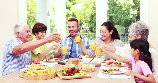 Multigenerational family enjoying breakfast around a sunlit table, sharing orange juice and healthy food. Ideal for concepts of family bonding, togetherness, healthy lifestyle, home life, and joyful mornings. Perfect for marketing materials, family-oriented content, or promoting healthy eating habits.