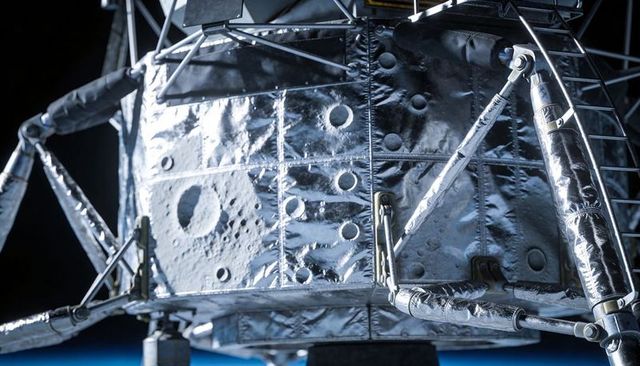 Lunar lander descent stage close-up with reflective thermal foil, struts and ladder at limb