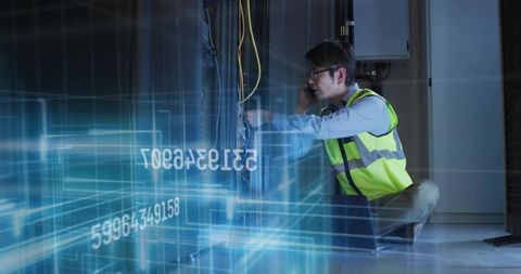 Technician managing cables in high-tech server room