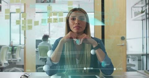 Businesswoman analyzing data on interactive holographic interface