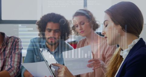 Diverse team engaged in business report analysis with digital data graphics