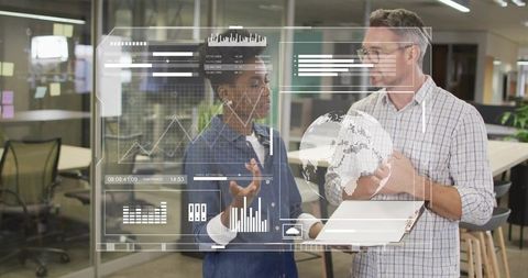 Coworkers reviewing holographic data dashboards with digital globe and tablet in open office