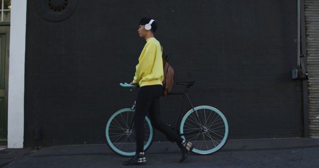 Young Adult Walking Bicycle While Listening to Music - Download Free Stock Images Pikwizard.com