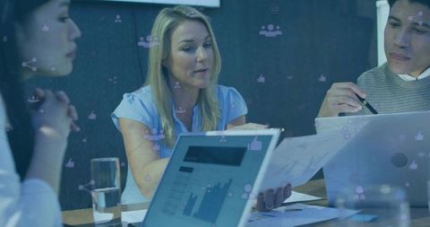 Strategic Teamwork Analyzing Data and Reports in Modern Office