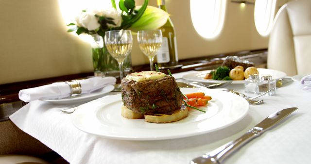 Gourmet meal served on a private jet, indicating luxury travel. Fine dining in the sky showcases the exclusivity and comfort of private aviation.