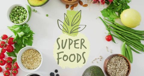 Flatlay superfoods spread with avocado, cherry tomatoes, seeds and greens for wellness