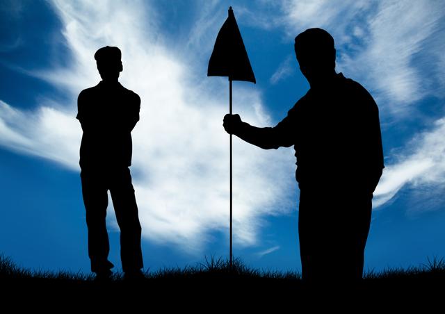Silhouetted golfers standing on grass with one holding a flag against a backdrop of a blue sky with clouds. Ideal for use in sports advertisements, golf event promotions, or articles about outdoor activities and teamwork.
