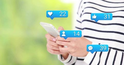 Woman holding smartphone with floating social media notifications on green bokeh backdrop