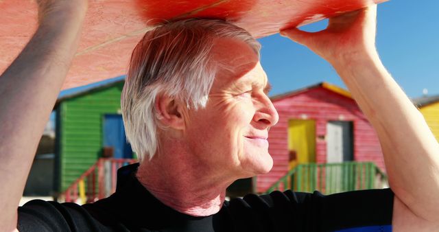 Senior Man Holding Surfboard in Sunny Beach Environment - Download Free Stock Images Pikwizard.com