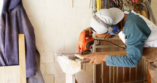 Carpenter Using Jigsaw to Cut Wood Board in Workshop - Download Free Stock Images Pikwizard.com