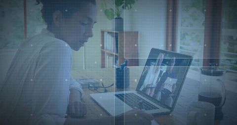 Woman leaning over laptop during remote meeting in bright minimalist home office