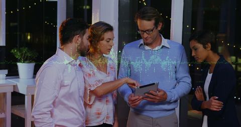 Diverse Business Team Analyzing Data on Tablet in Office